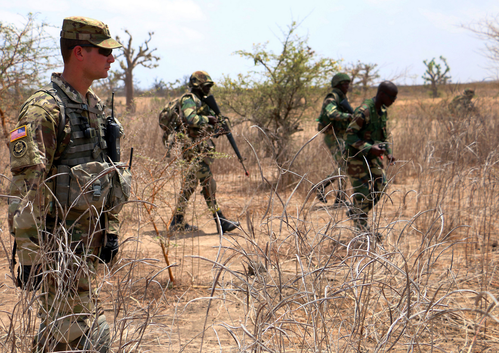 Capt. Andrew Murphree, commander of Bravo Company, 1st Battalion, 30th Infantry Regiment, 2nd Infantry Brigade Combat Team, 3rd Infantry Division, observes Senegalese soldiers bound toward an objective during a squad-level exercise July 13, 2016 in Thies, Senegal as part of Africa Readiness Training 2016. ART 2016 is a US Army Africa exercise designed to increase US and Senegalese readiness and partnership through combined infantry training and live fire events. (US Army Africa photo by Staff Sgt. Candace Mundt)